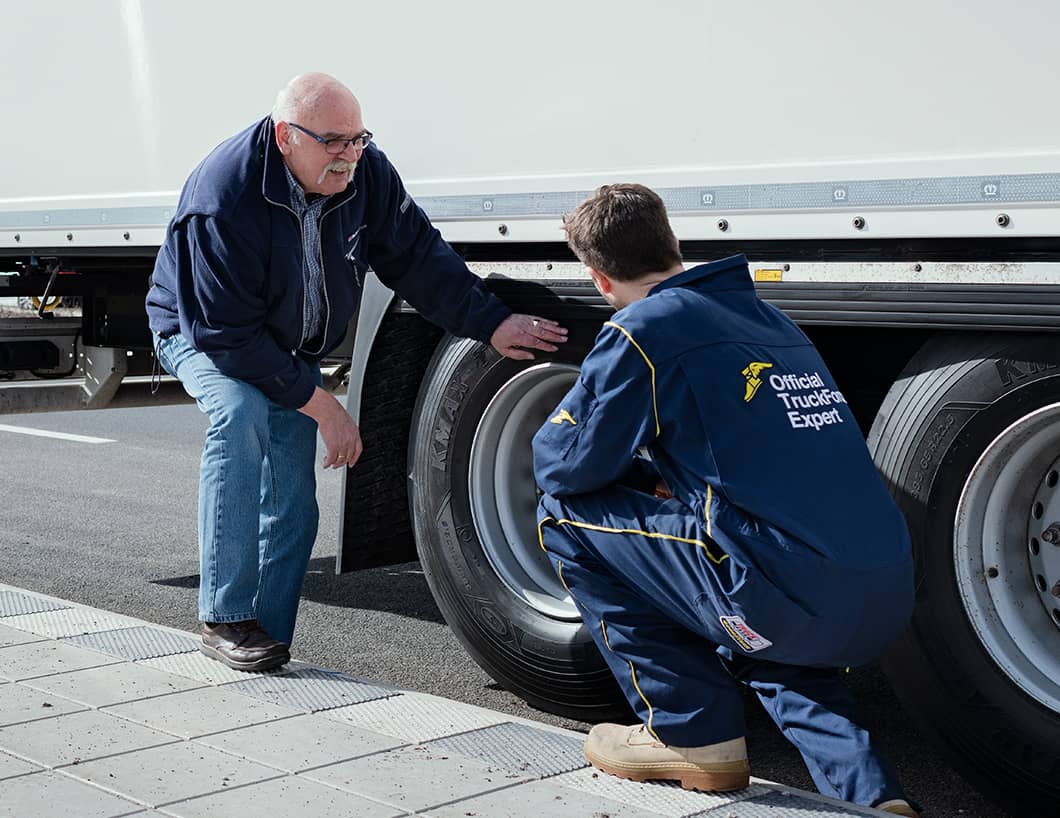 Goodyear Truckforce expert advising truck driver on trailer tyres on the side of the road