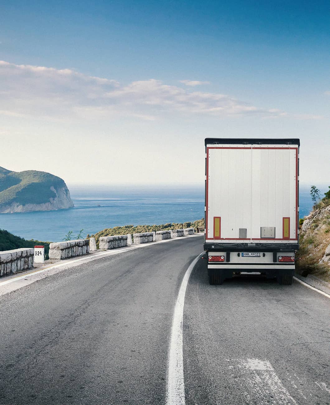 TPMS-fitted white commercial fleet truck driving around corner